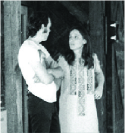 Black and white photo of a man and a woman talking to each other